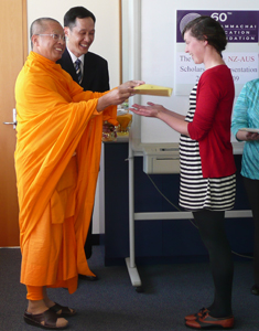 Ven. Sudhammo presents a scholarship to Sarah Baillie