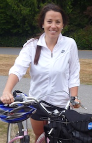 Photo of Amy McColl standing with her bicycle