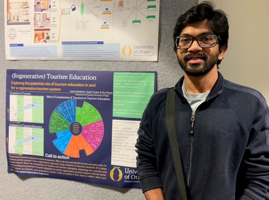 A man standing next to a poster 