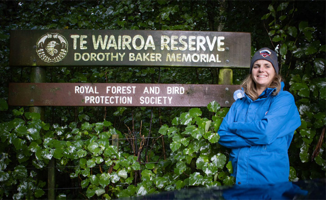 woman standing in front of sign