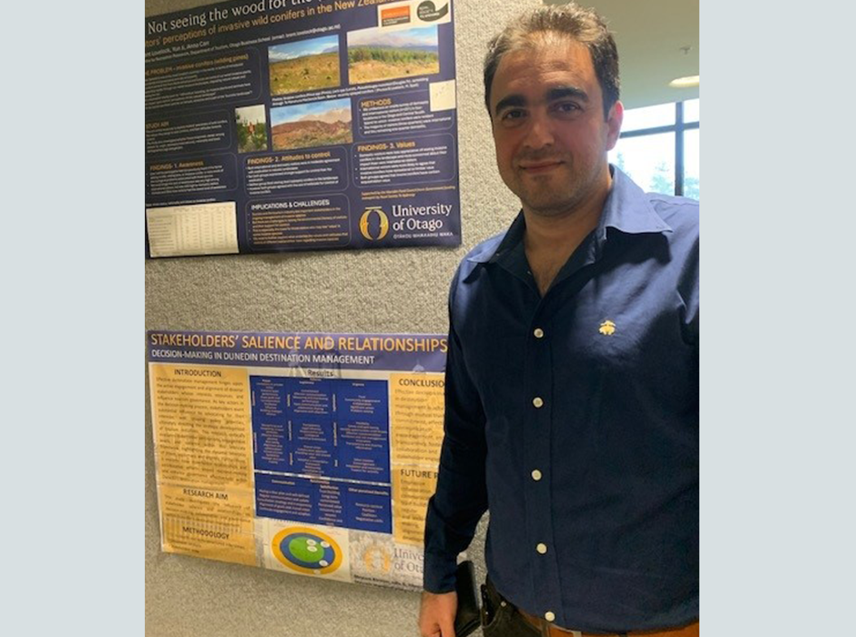 A man standing next to a poster 
