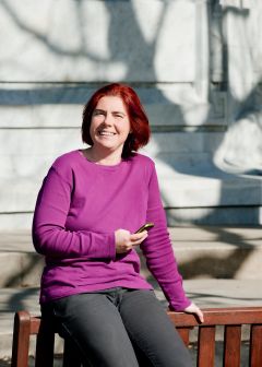 Maria Polak leaning on park bench in the sun