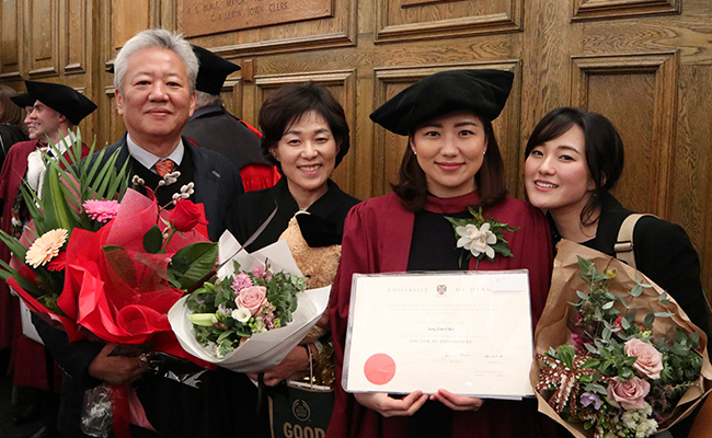 Joanne Choi PhD graduation day, with her parents and younger sister image