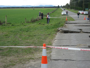 Cracked tarseal and uplift across the fault scarp as it crosses a road. This may be a restraining bend in the fault.