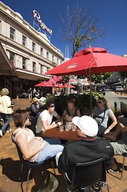 Photo of people sitting at tables at an outdoor cafe