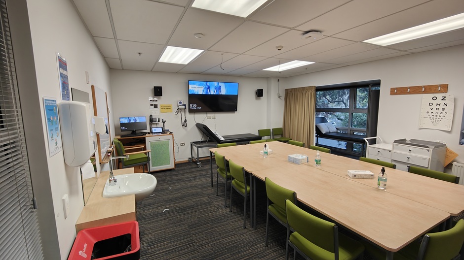 Setup of Hunter Centre rooms HU102-3-5-6-8-9-11 showing chairs around a table, and medical equipment