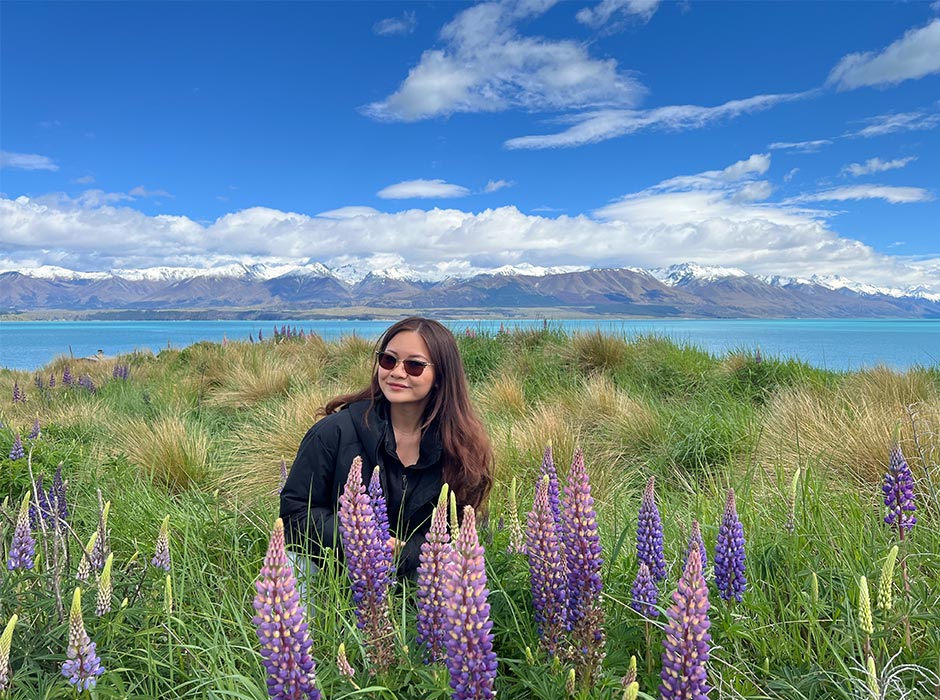 Feng Chen enjoying nature in a field of flowers.