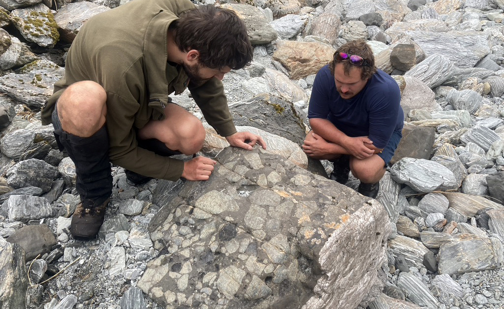 Marshall Palmer and Felix Schmidt study peridotite xenoliths and amphibole megacrysts in a lamprophyre dike in the Southern Alps.