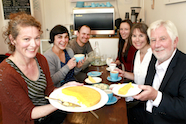 Photo of Keely McGlynn and guests at her cafe which promotes health portions of food.