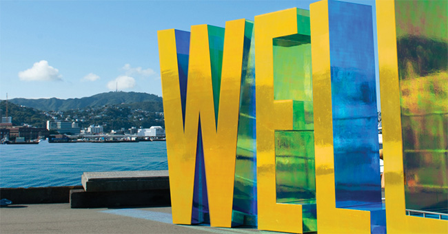 Wellington harbour, with giant letters spelling 'WELL' on the quayside in the foreground