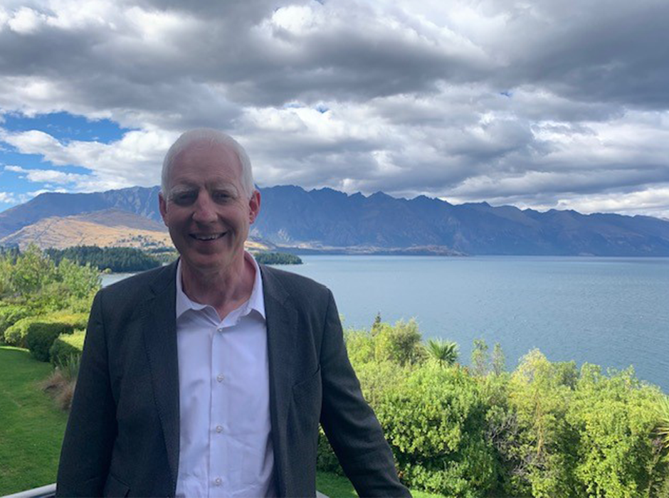 A man standing in front of nice scenery 