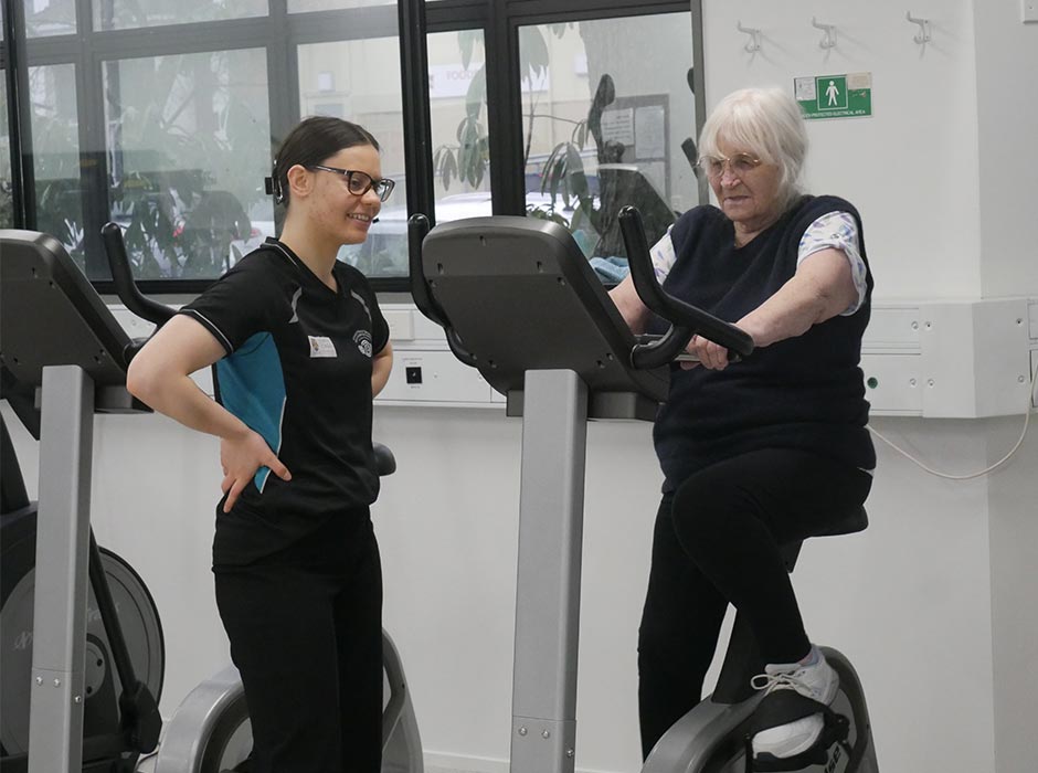 Clinical Exercise Physiology student Aliya Mottus (left) supervises client Pat Downing.