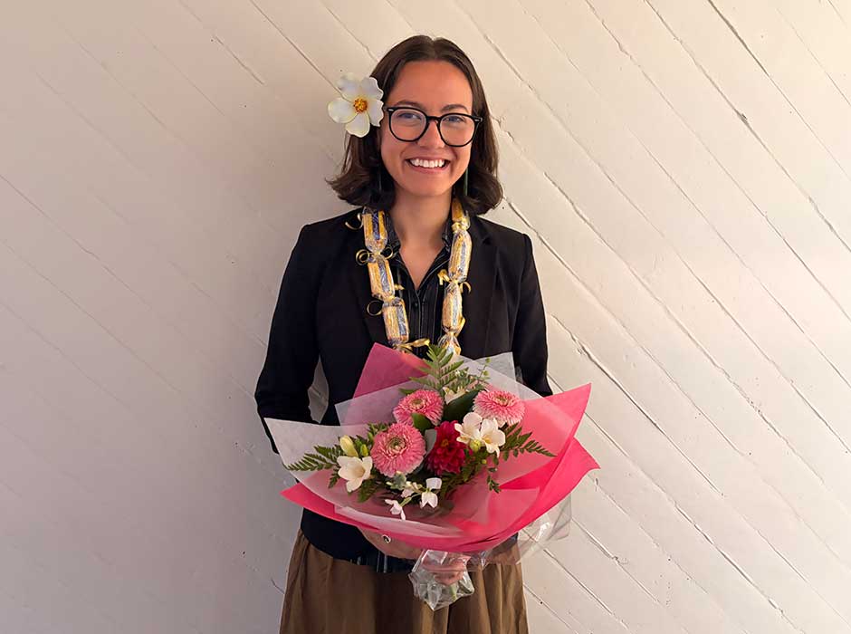 A woman standing holding a bouquet of flowers 