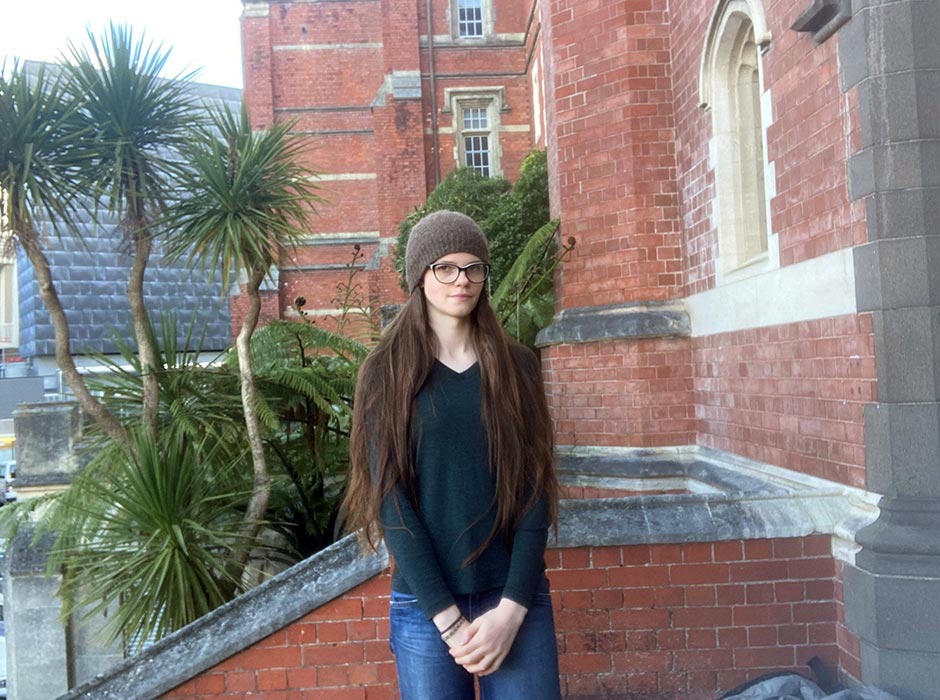 A girl in a beanie standing in front of Victoria University's Hunter building