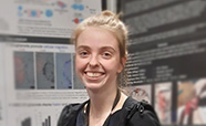 Laura Veenendaal in front of her winning poster thumbnail