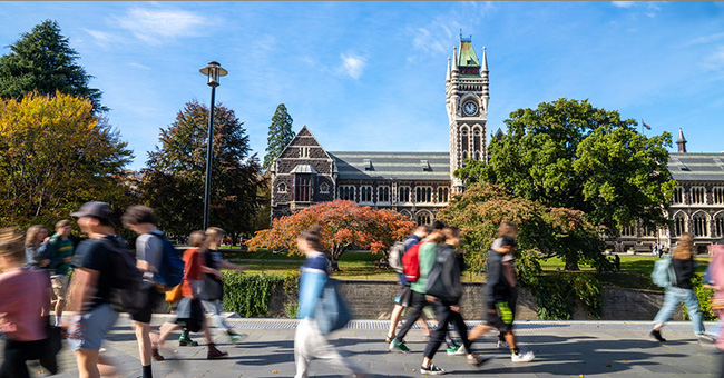 Students walking through Dunedin campus, with the Clocktower Building visible in the background