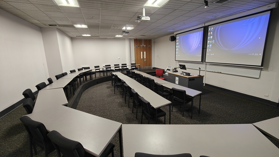 View of Otago Business School room LG05, showing tables and chairs in a small lecture theatre layout