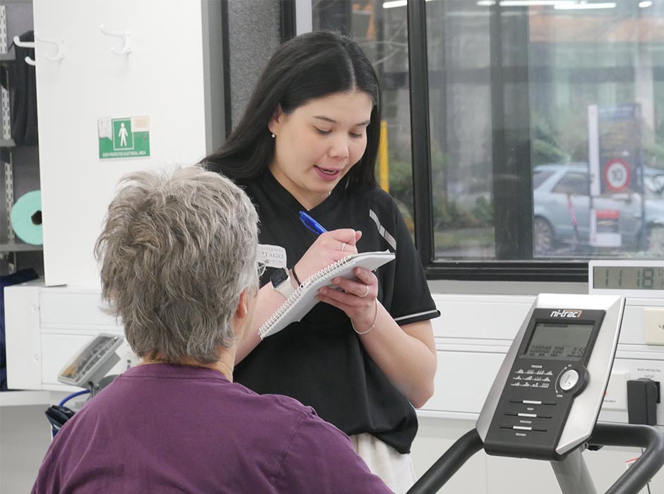 Clinical Exercise Physiology student Maxine McIvor takes notes as she talks to a client. 