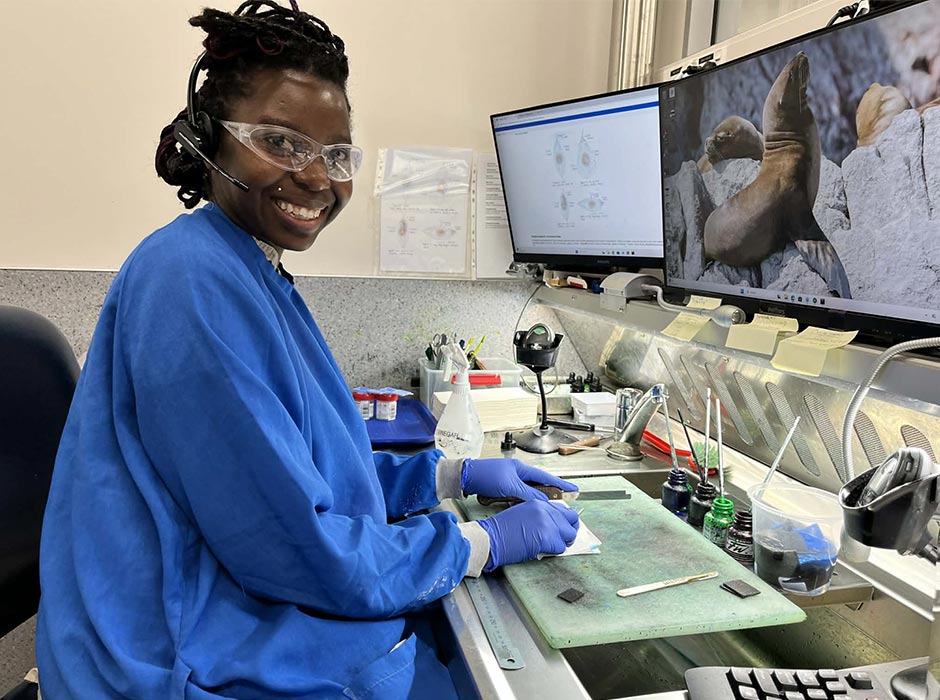 A woman wearing scrubs working in a lab