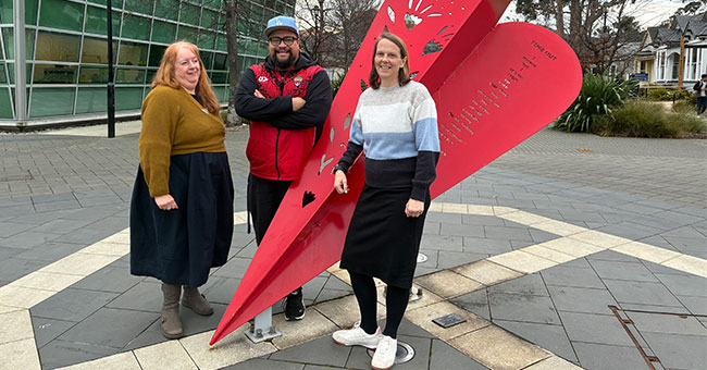 Professor Sarah Wakes (Mathematics), Senior Lecturer Edmond Fehoko (Human Nutrition), and Professor Katherine Black (Human Nutrition), stand infront of artwork on the University of Otago campus. 