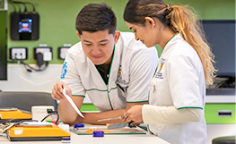 Pharmacy students using lab equipment
