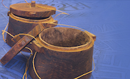 Pacific wooden pots on blue cloth thumb