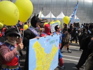 children holding balloons in climate action march in Seoul