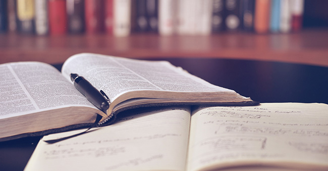 Two open books lying on a desk.