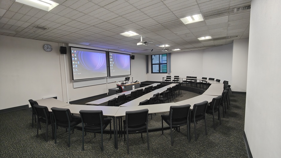 View of Otago Business School room LG05, showing tables and chairs in a small lecture theatre layout