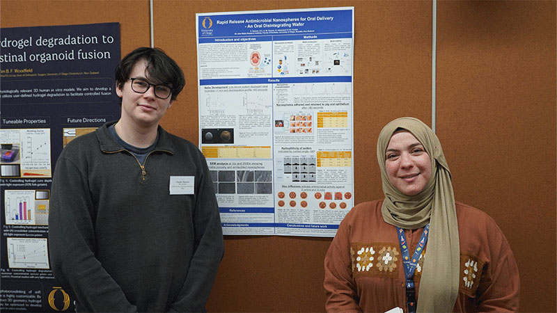 two people standing either side of a poster