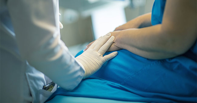 A generic image of a medical professional comforting a patient.