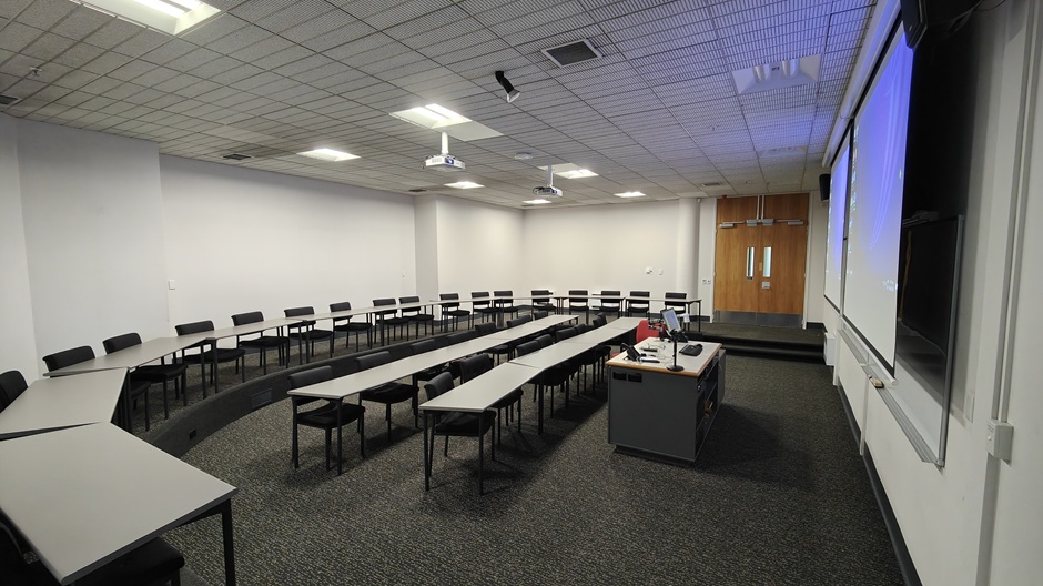 View of Otago Business School room LG05, showing tables and chairs in a small lecture theatre layout