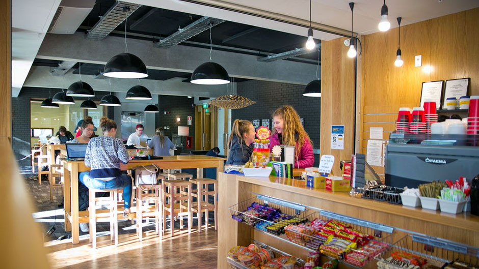 Inside view of the Marsh Study Centre, showing coffee and snack items for sale and students working at tables in the background