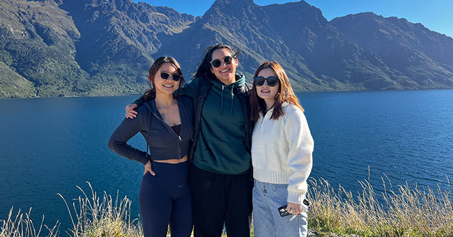 From left: Feng Chen, Gayathri Ponneri and Valentine Sheng enjoying nature near a lake.
