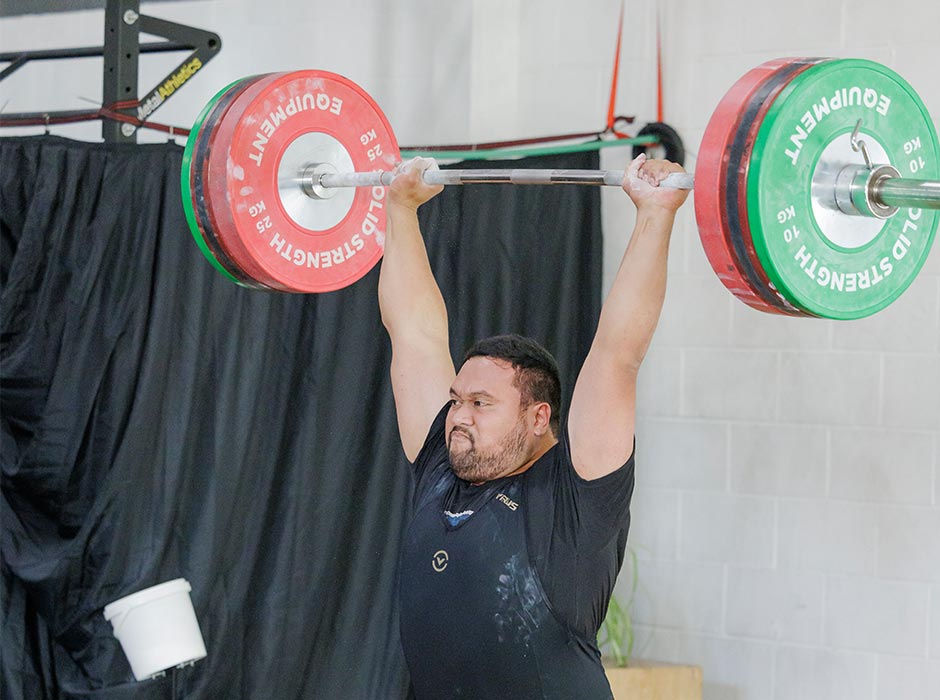 A man lifts weights in a competition.