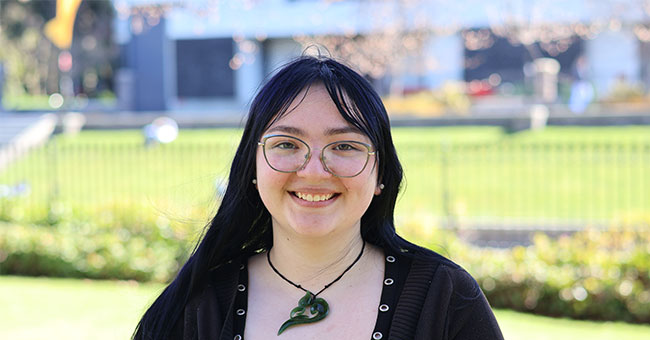 A young woman wearing glasses is pictured on the Dunedin campus. 