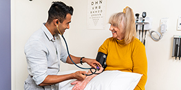 Medical student consulting with patient