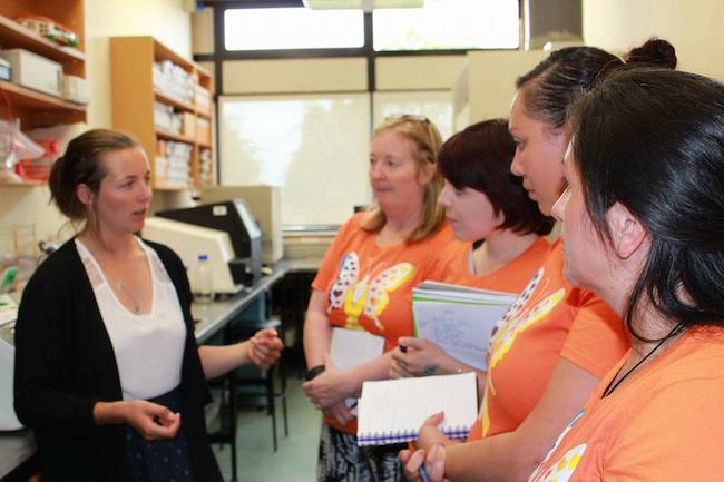 Researcher Bryony Telford explains some of the technical aspects of cancer research to a small group