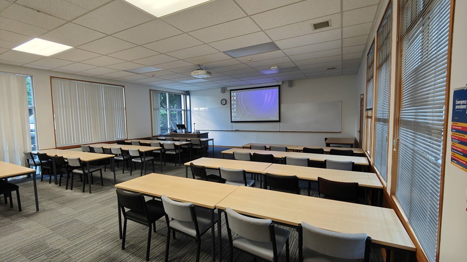 A view of Ōwheo building seminar room G34, showing rows of tables and chairs