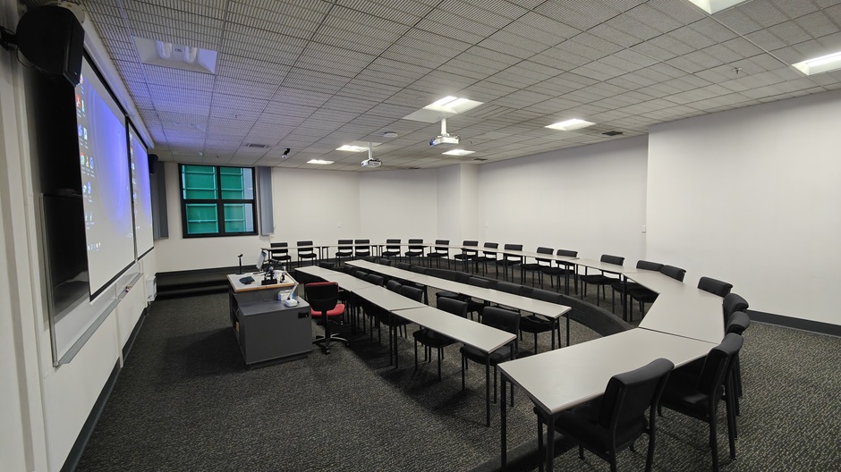 View of Otago Business School room LG05, showing tables and chairs in a small lecture theatre layout