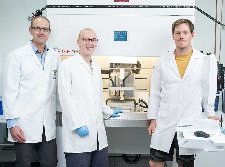 Three people standing in a lab