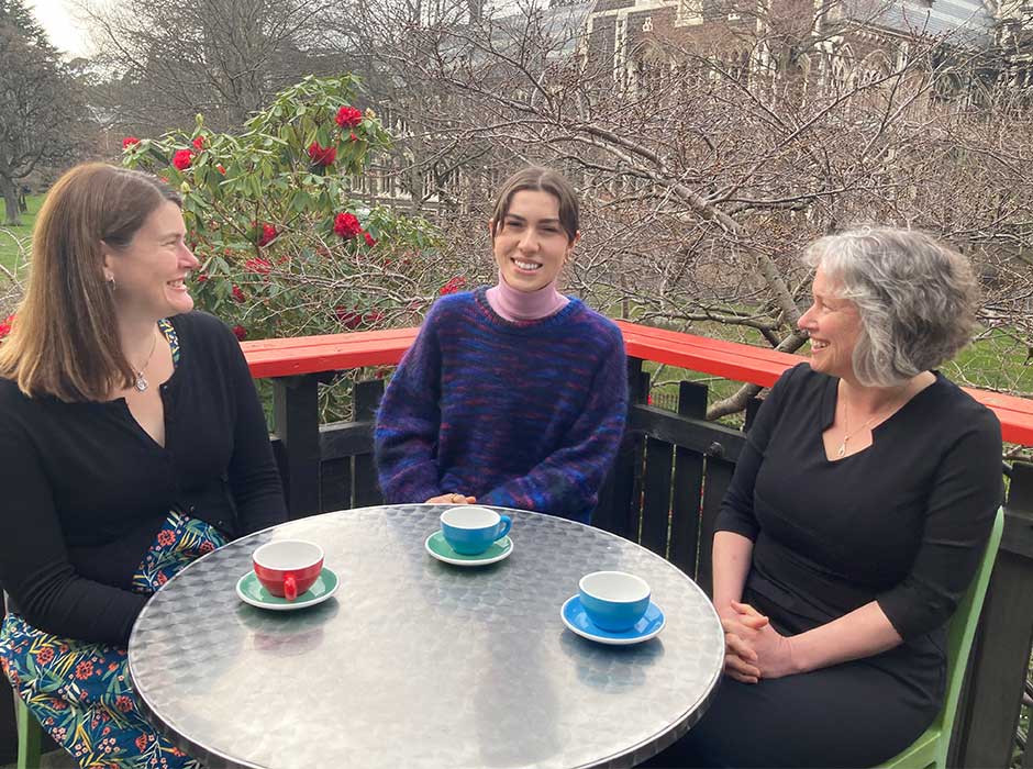 Three woman sitting at a table at a cafe 