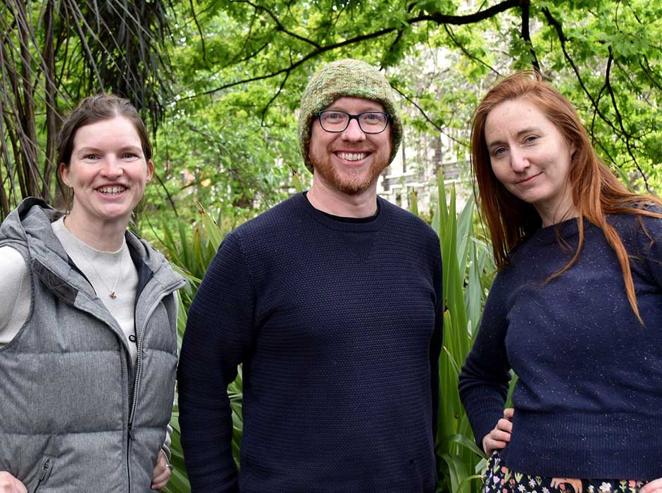 Three people with trees behind them 