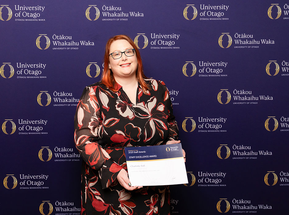 a woman holding a certificate 