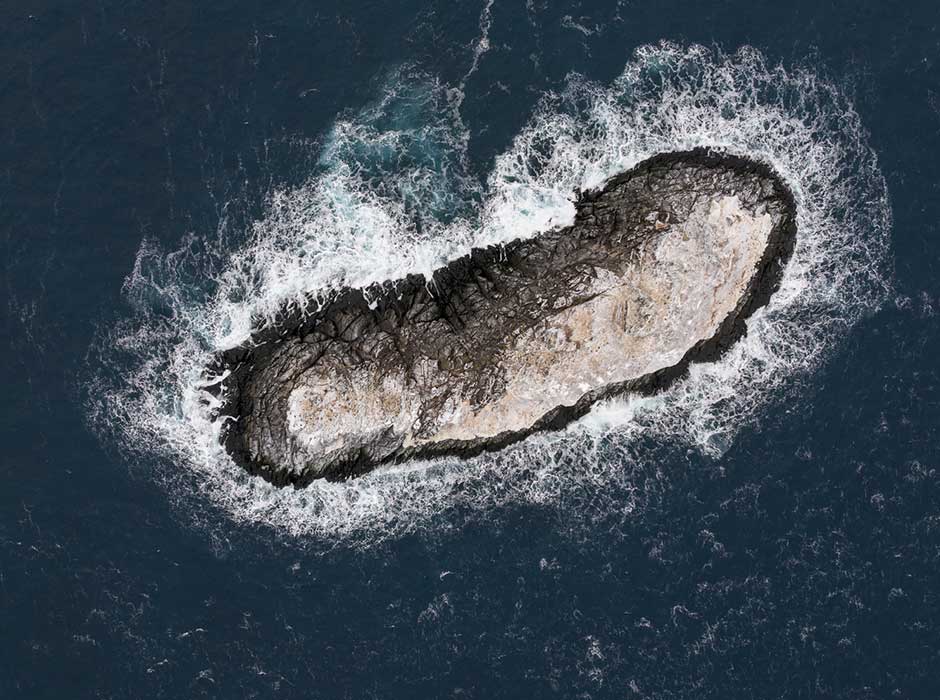 An aerial view of a small island made of rocks