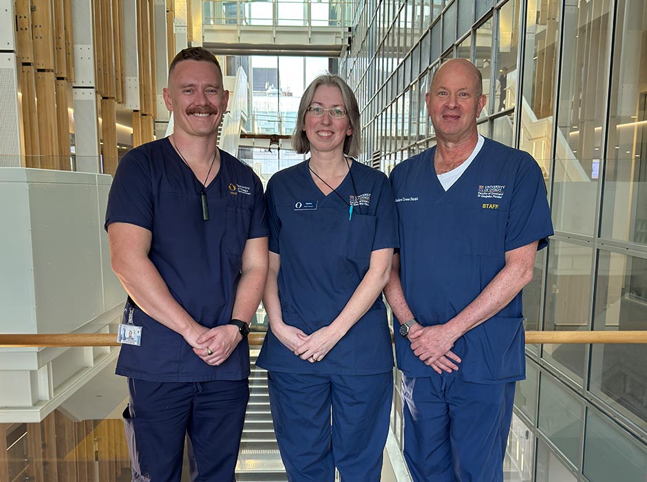 Three people in dental uniforms pose for a picture.