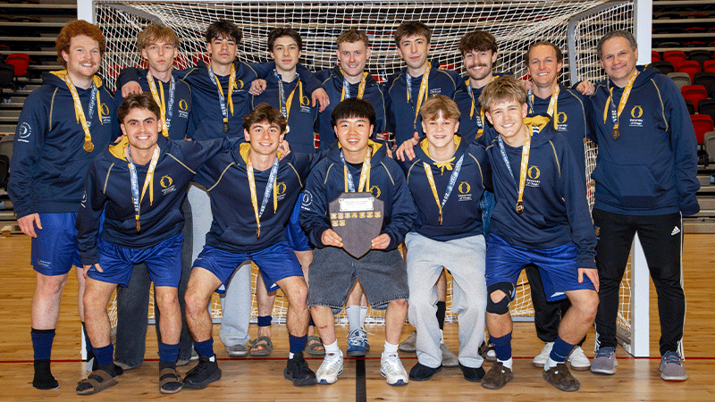 a mens futsal team in front of a goal