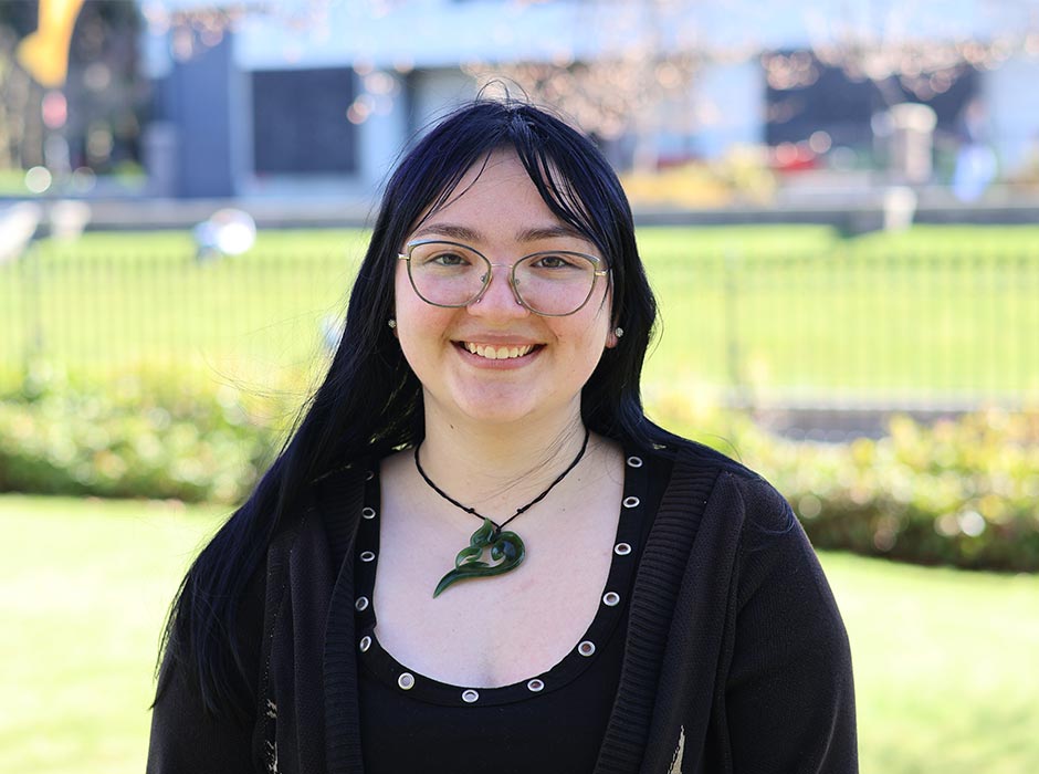 A young woman wearing glasses is pictured on the Dunedin campus. 