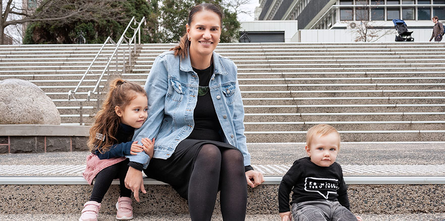 Karyn Paringatai with children Manuhou and Matahi sitting on outside stairs