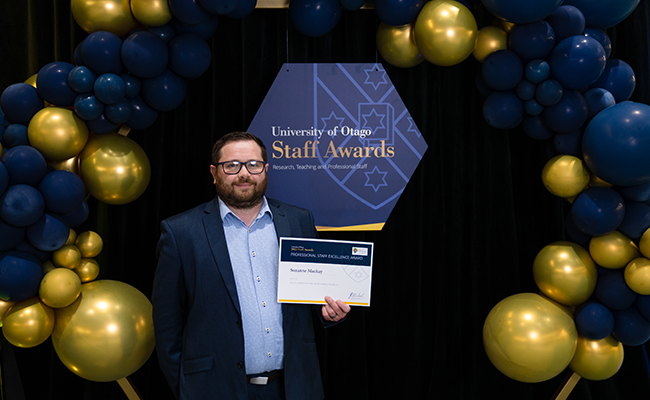 Michael Hodge receives Suzanne Mackay's staff award on her behalf image